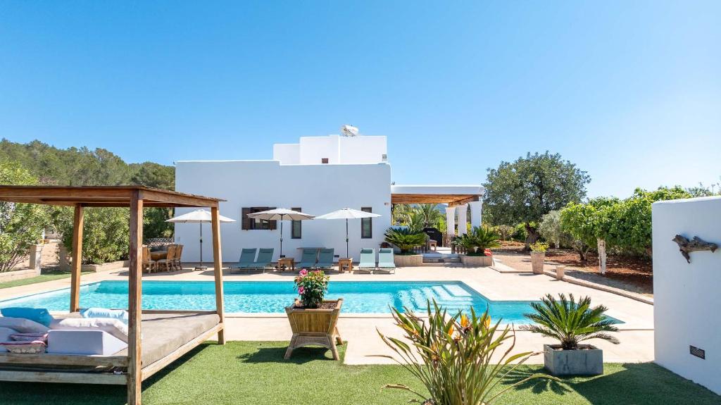 a villa with a swimming pool and a house at Villa Can Lloren in Sant Llorenç de Balafia