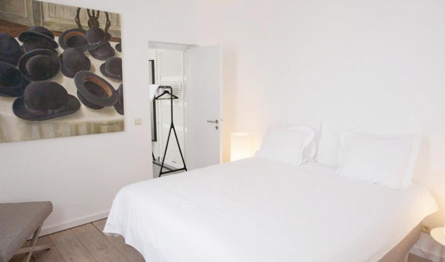 Postel nebo postele na pokoji v ubytování Hotel des Galeries