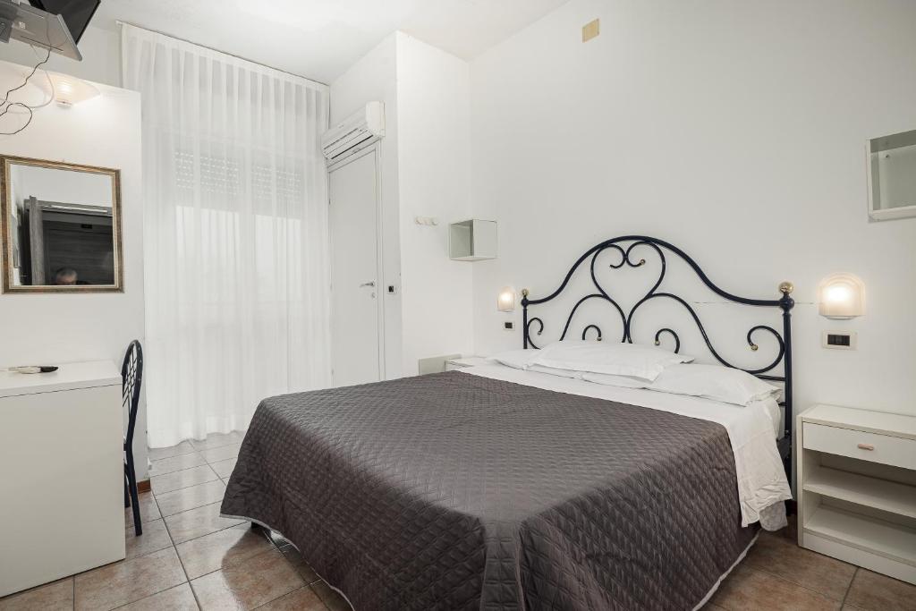 Postel nebo postele na pokoji v ubytování BI Hotel