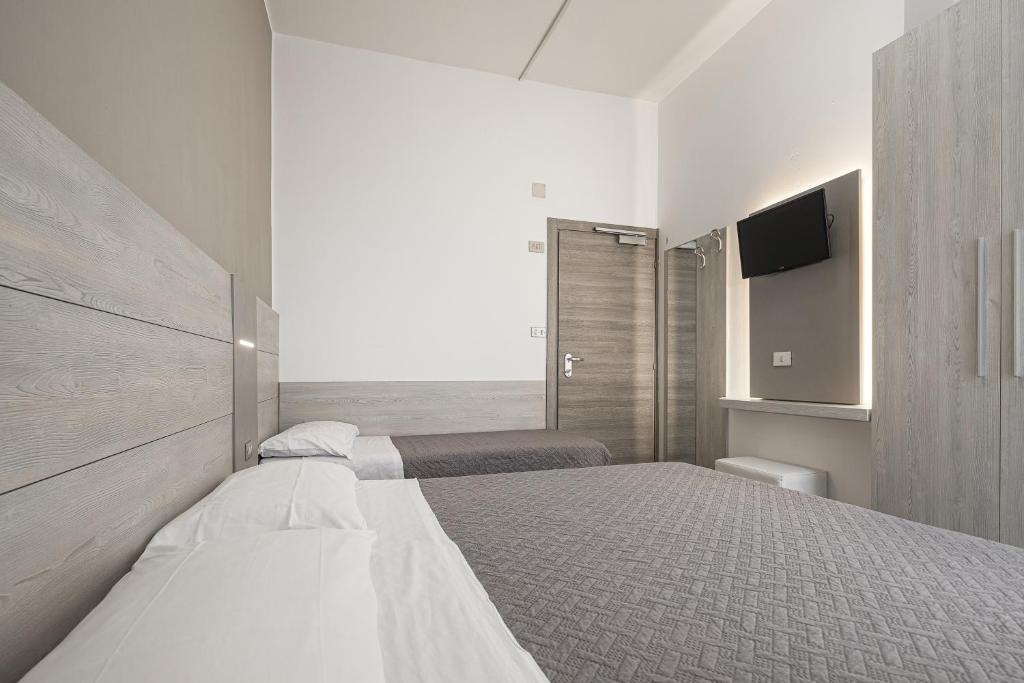 Postel nebo postele na pokoji v ubytování BI Hotel