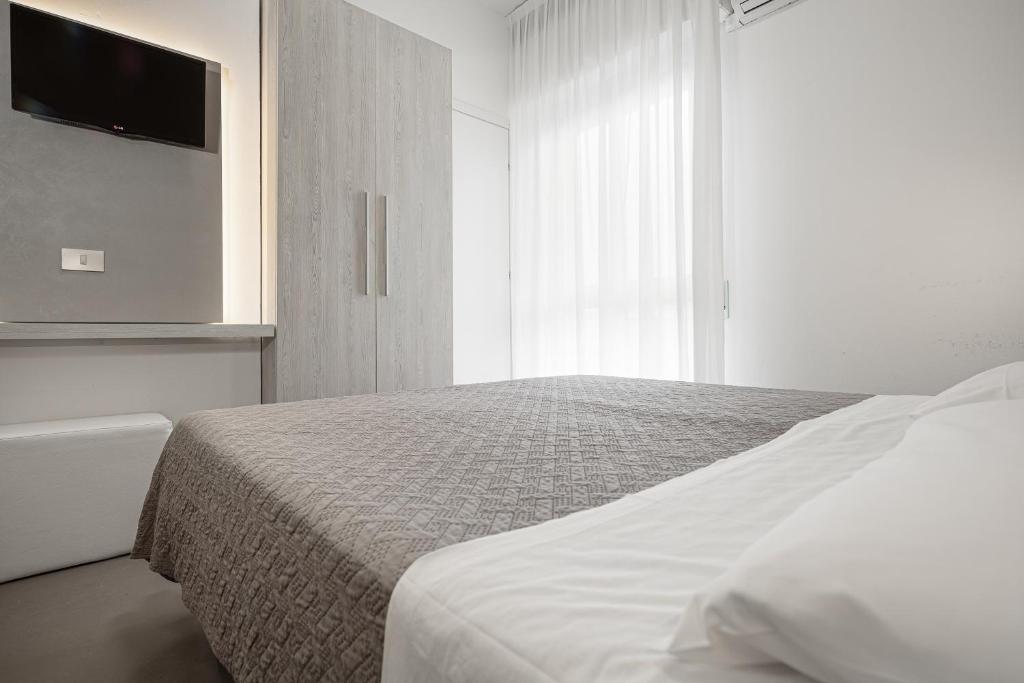 Postel nebo postele na pokoji v ubytování BI Hotel