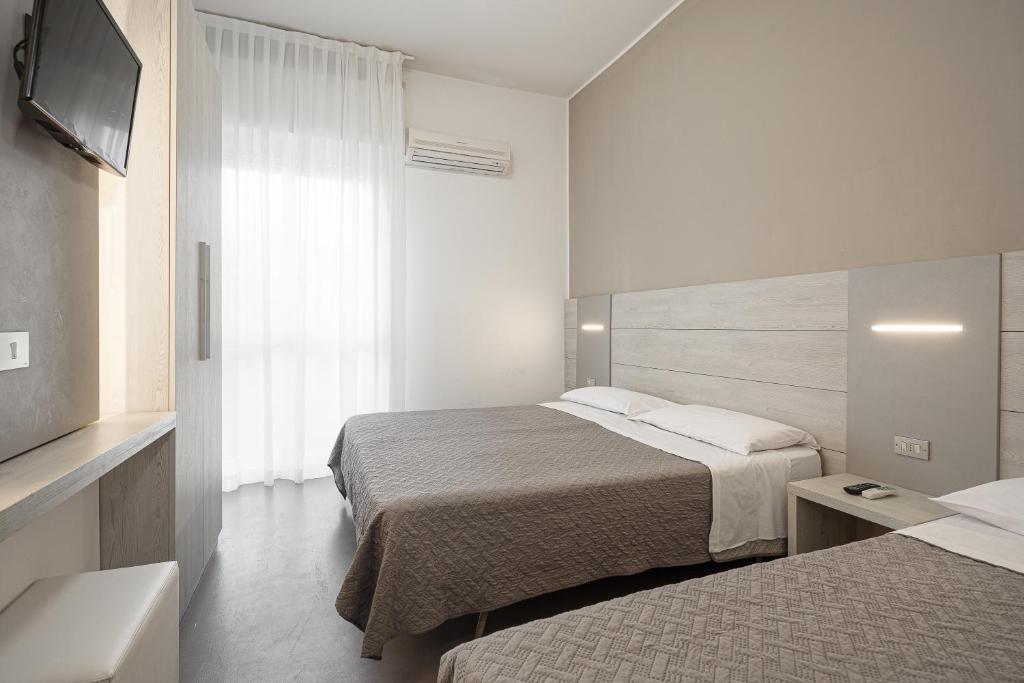 Postel nebo postele na pokoji v ubytování BI Hotel
