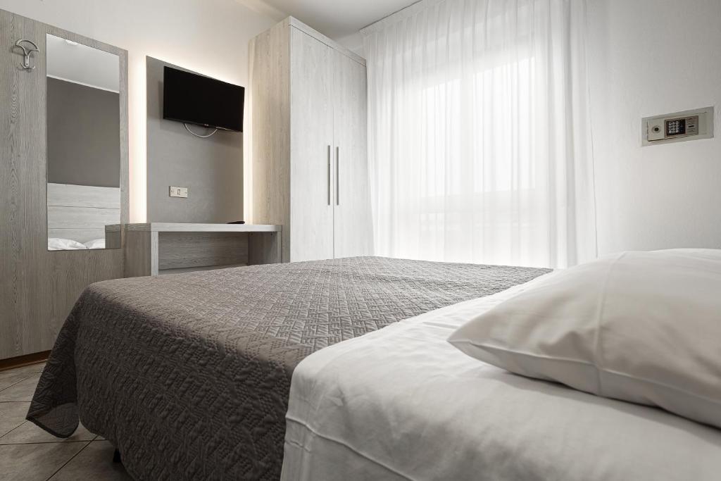 Postel nebo postele na pokoji v ubytování BI Hotel