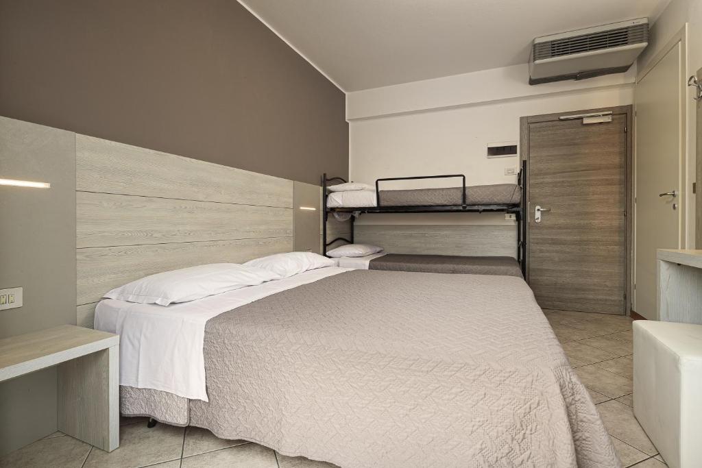 Postel nebo postele na pokoji v ubytování BI Hotel