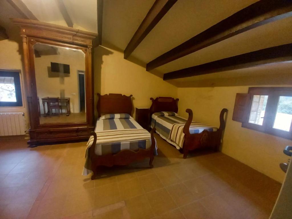 A bed or beds in a room at Hostal Rural Mas Blanc