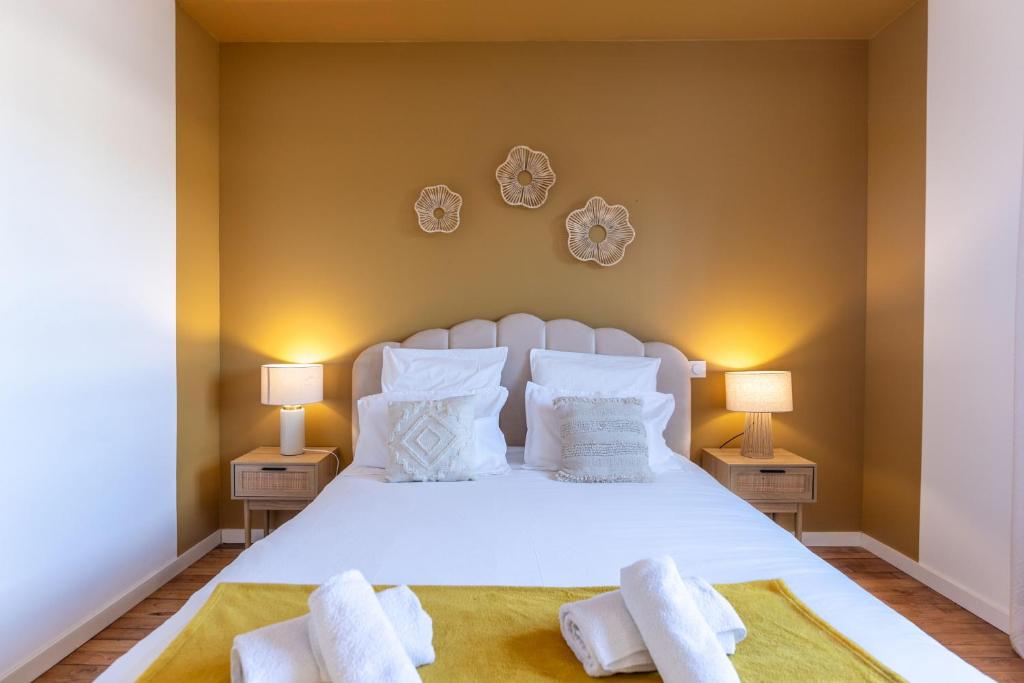 - une chambre avec un lit blanc et 2 lampes dans l'établissement Le Boho - Charmant T3 avec climatisation et fibre, à Bergerac