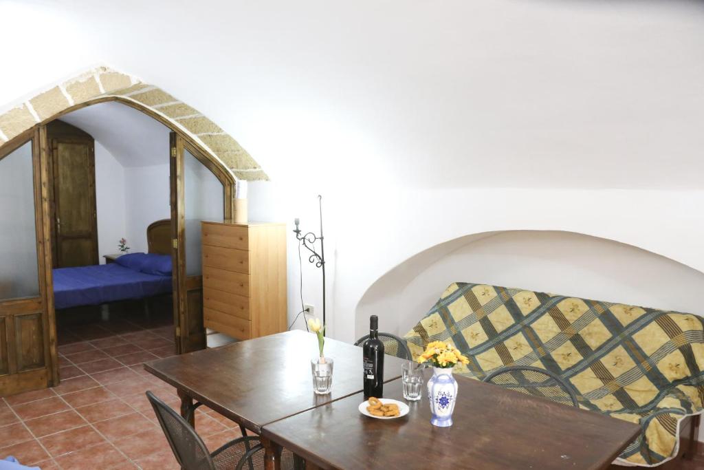 a dining room with a table and a couch at Corte De Tomasi- Centro storico in Gallipoli