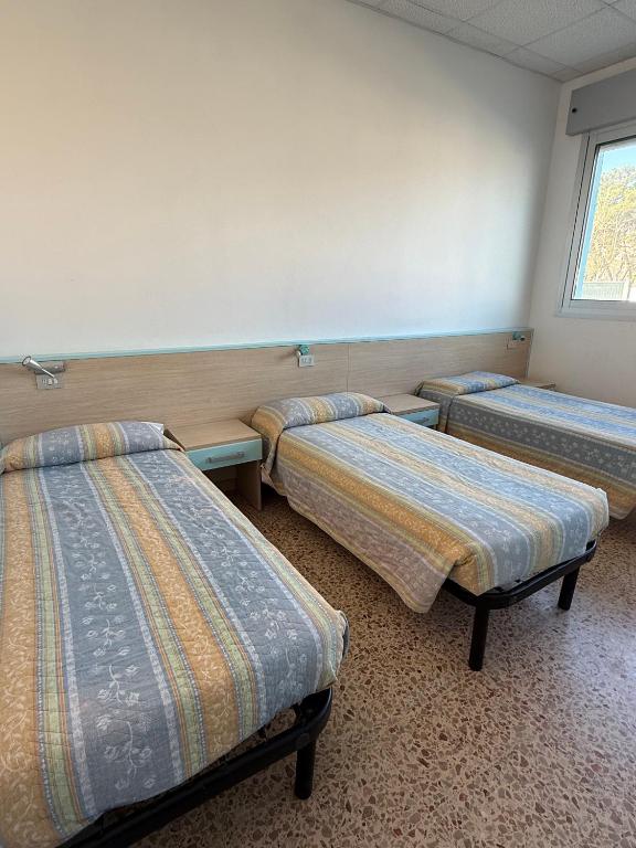 Postel nebo postele na pokoji v ubytování Ostello Casa Celeste sul Mare
