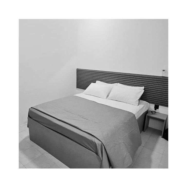 Postel nebo postele na pokoji v ubytování Reinforce Residence