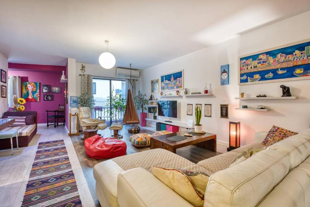 a living room with a couch and a table at Central + Bright Apartment in St. Julians in St. Julianʼs
