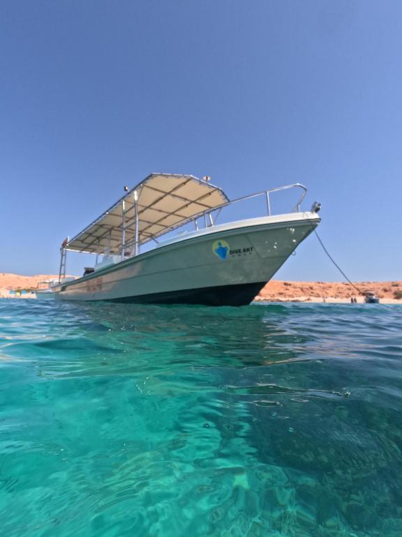 a boat sitting on the water in the ocean at Dive Art Oman in Ma‘ābīlah