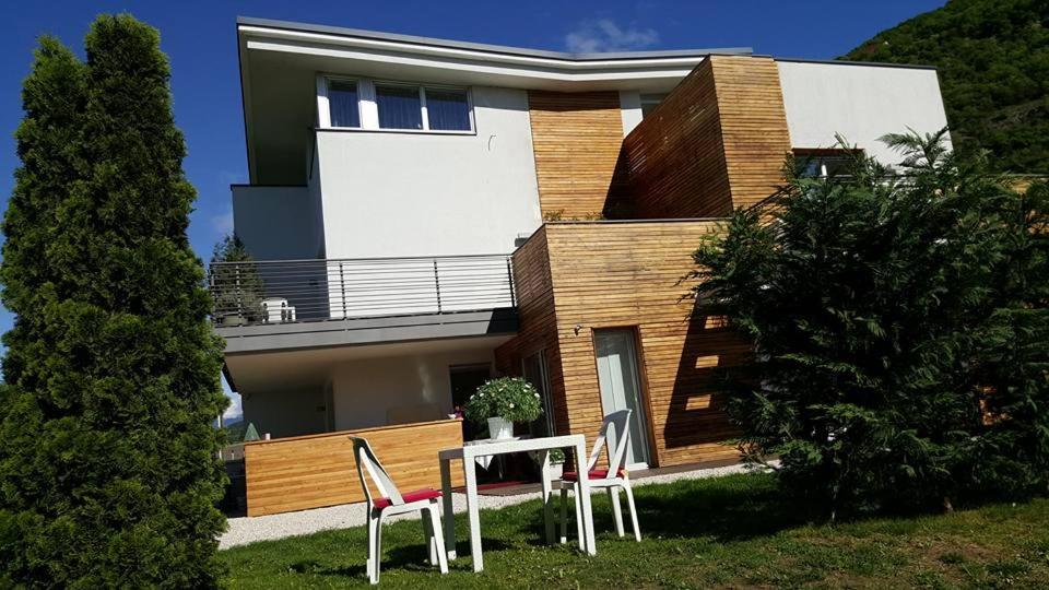 a house with a table and chairs in front of it at B&B Mele d'Oro in Bolzano