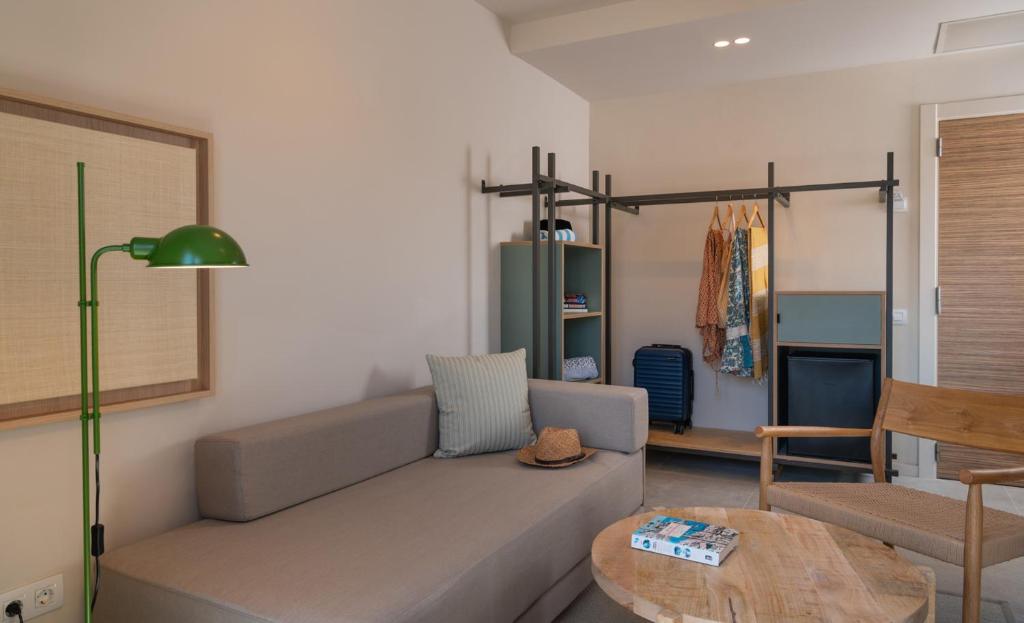 a living room with a couch and a table at AQUA Hotel Bertran Park in Lloret de Mar