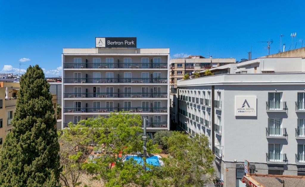 an apartment building with a sign on top of it at AQUA Hotel Bertran Park in Lloret de Mar