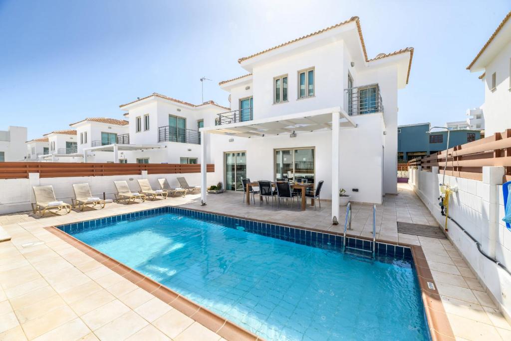 a villa with a swimming pool and a house at Sunrise Bay Villa #2 in Protaras