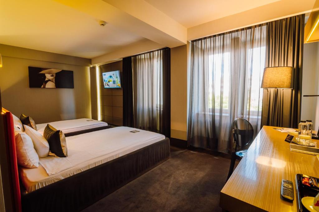 Postel nebo postele na pokoji v ubytování Plaza V Hotel