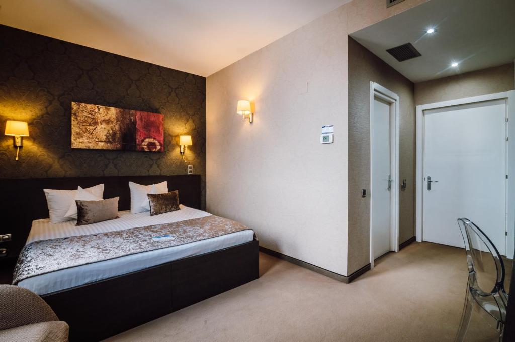Postel nebo postele na pokoji v ubytování Plaza V Hotel