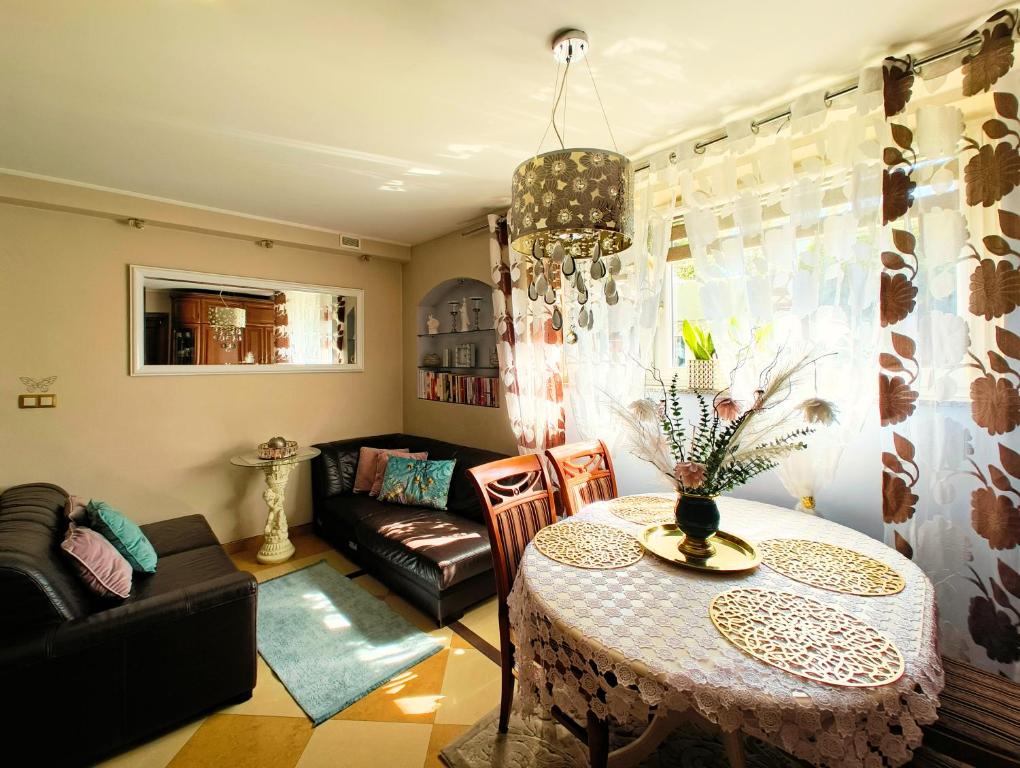 a living room with a table and a couch at MAYA apartament in Jantar