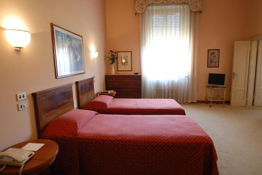 Postel nebo postele na pokoji v ubytování Hotel Palace Bologna Centro