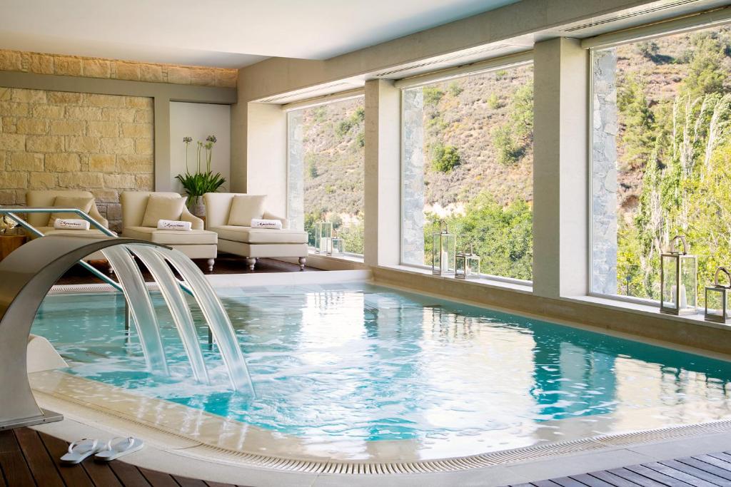 a pool in a house with windows at Casale Panayiotis in Kalopanayiotis