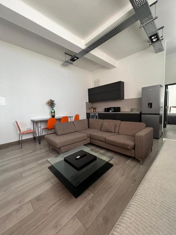 a living room with a couch and a table at Modern 2bed warehouse conversion apartment for 6 people - London in London
