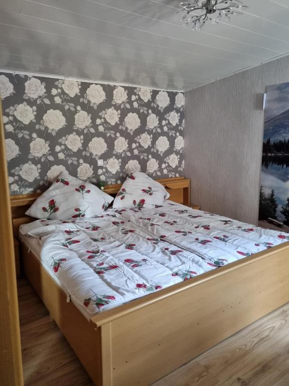a bedroom with a bed with white blankets and pillows at Ferienhaus Hochwald in Wadern