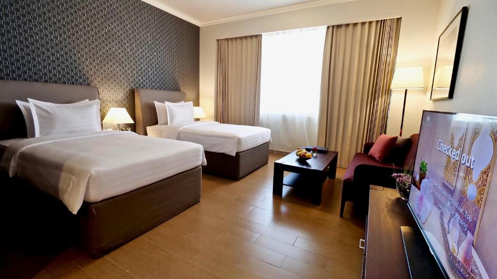 White Square Curve Hotel & Suites客房内的一张或多张床位