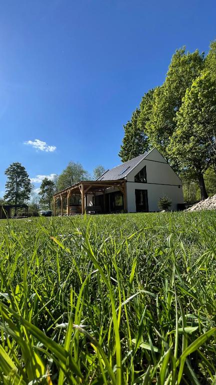 a house in the middle of a field of grass at Domek w Górach Wilkanów Park in Wilkanów