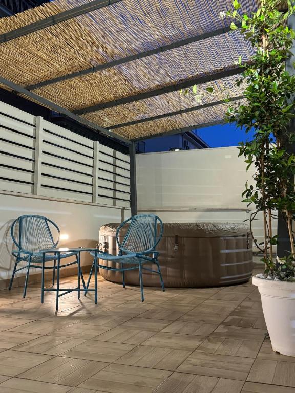 two chairs and a table on a patio at Le Case di PA in Anzio