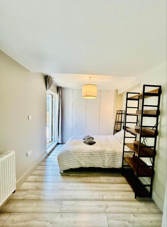 a bedroom with a bed and a ladder at Heart of Dalston East London in London