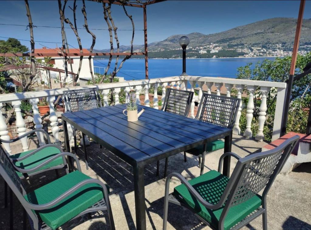 a blue table and chairs with a view of the water at Charming Apartments Dalmatian Misto Čiovo in Okrug Donji