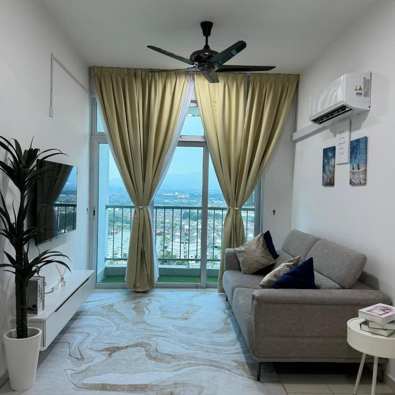 a living room with a couch and a large window at Sky9Haven Homestay in Ipoh