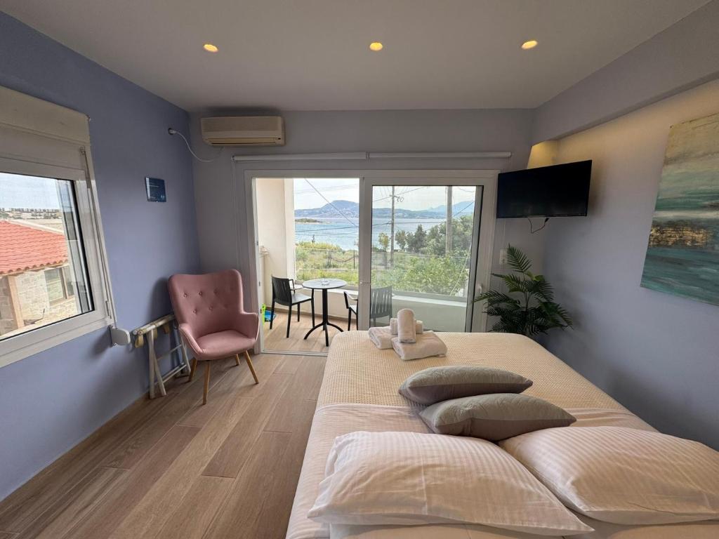 a bedroom with a large bed with a large window at Eleftherias Suites - Near Beach Apartments in Marathi