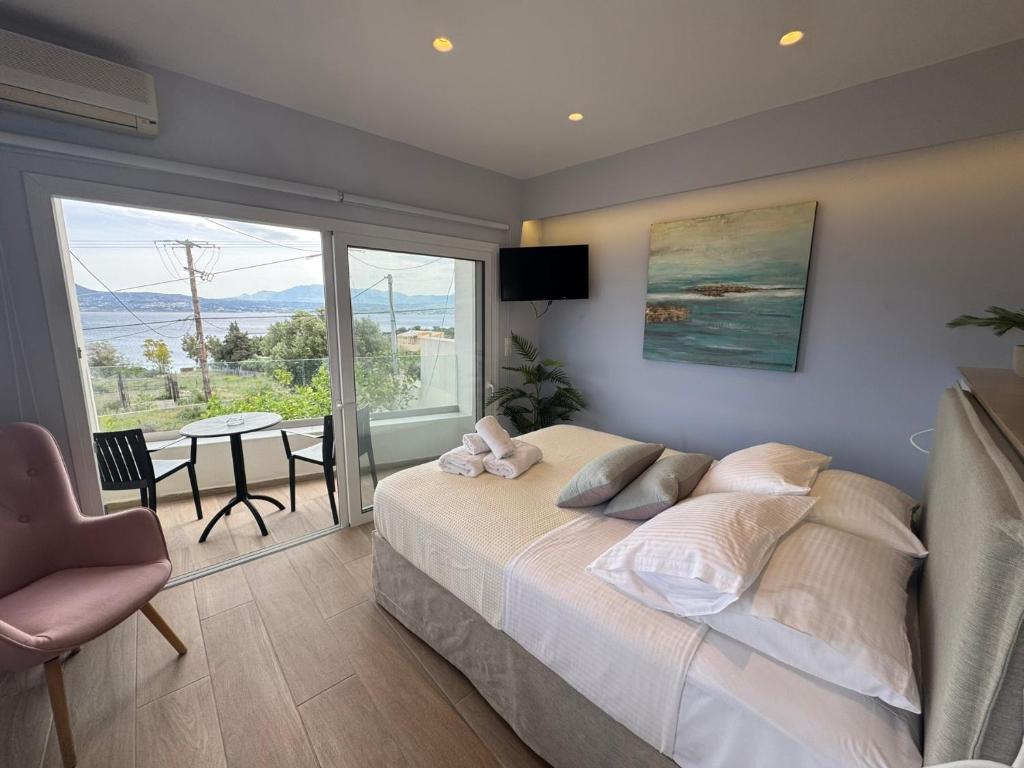 a bedroom with a large bed and a table with chairs at Eleftherias Suites - Near Beach Apartments in Marathi