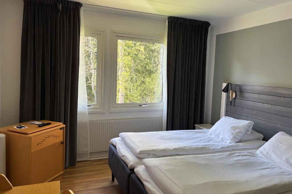 Postel nebo postele na pokoji v ubytování Hotel Ullinge