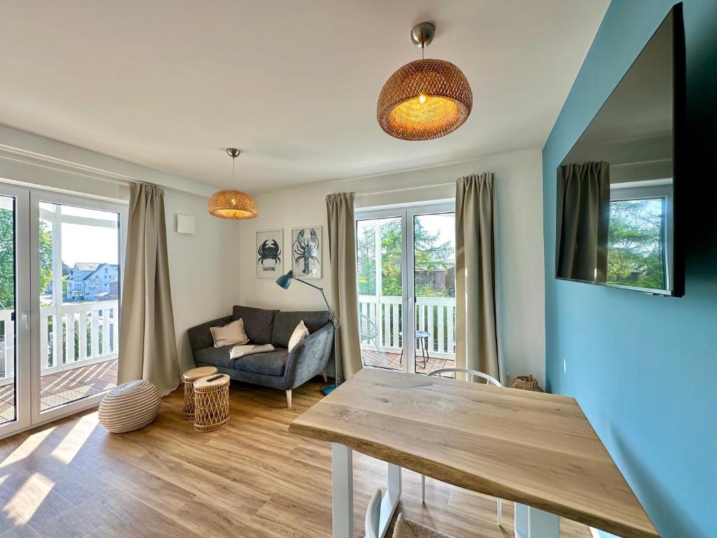a living room with a table and a couch at Salt & Sand Wohnung Sea in Haffkrug