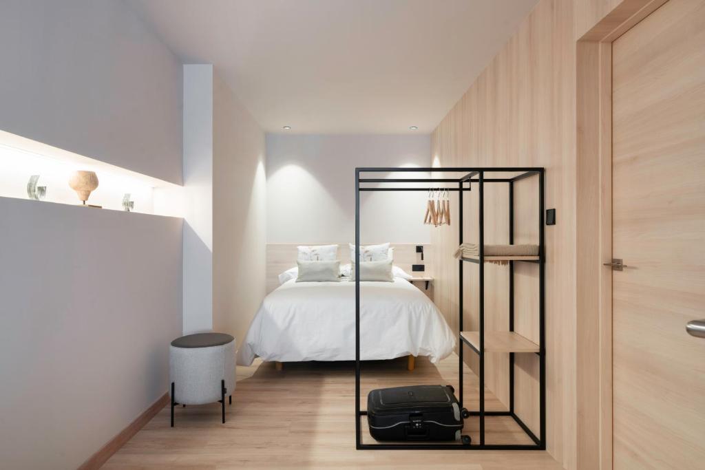 a bedroom with a bed and a book shelf at Apartamentos Ca Gracia 1 Estándar in Bocairent