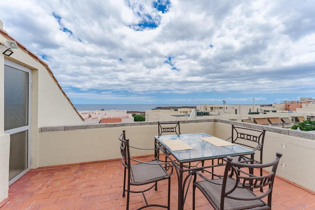 a patio with a table and chairs on a balcony at Spacious apartment with the private terrace in Arona