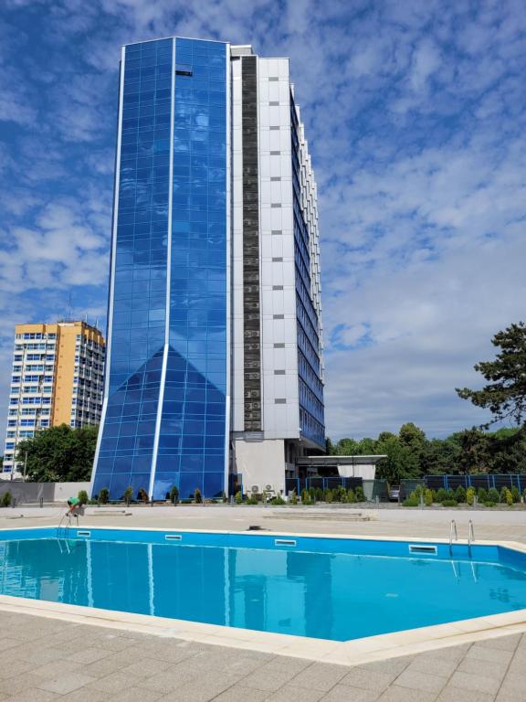 a building with a swimming pool in front of a building at Olimp sea view apartments - 802 in Olimp