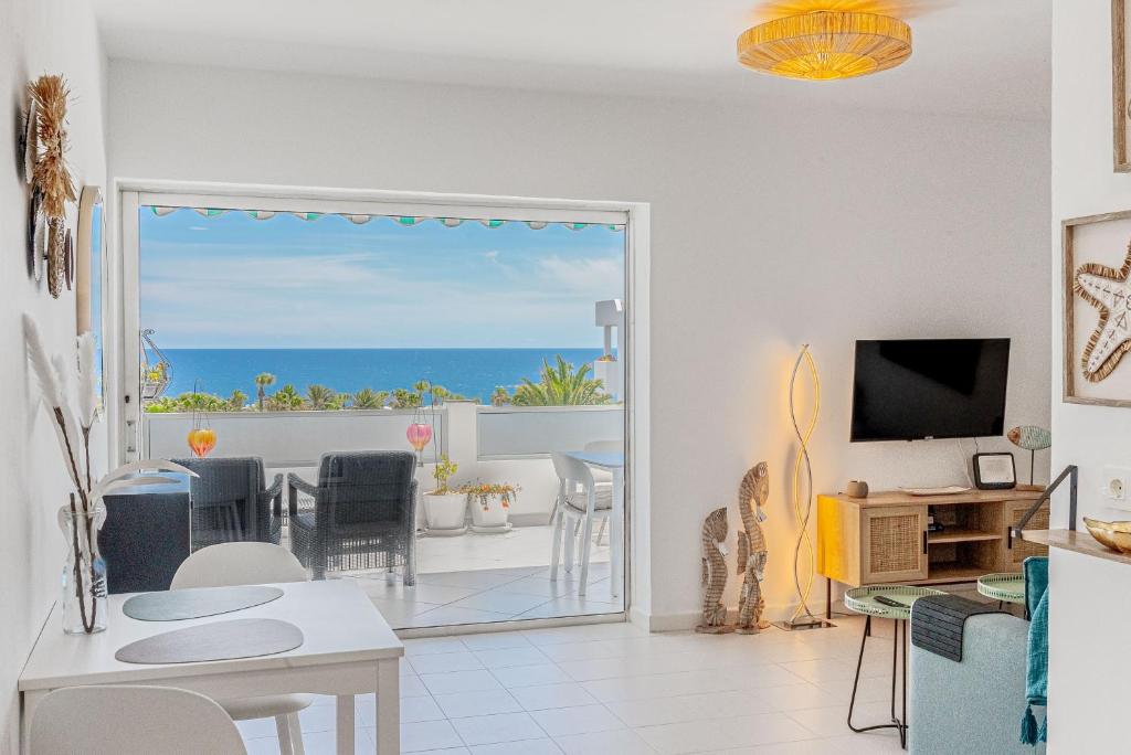 a living room with a view of the ocean at Lolas in Puerto del Carmen