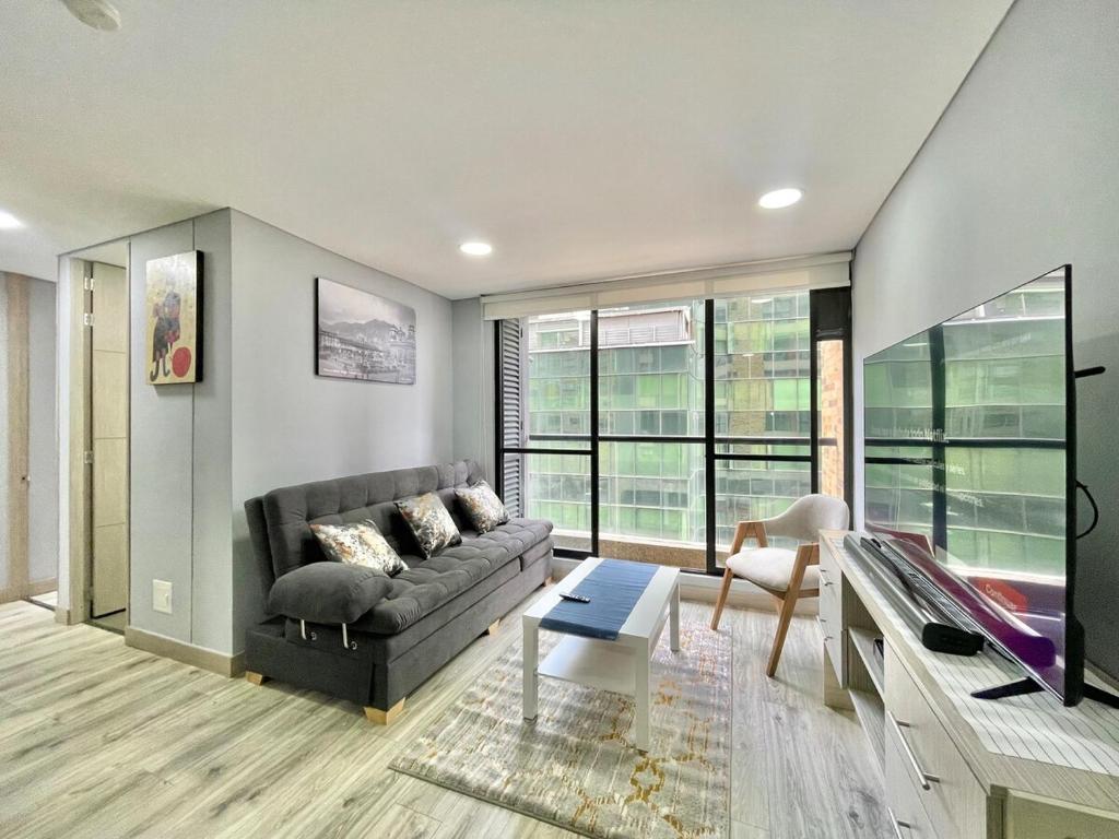 a living room with a couch and a table at New Cozy and Modern Gym Coworking Terrace in Bogotá