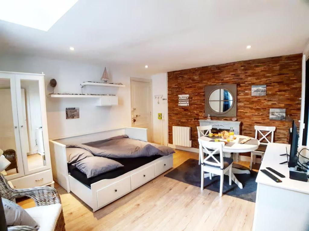 - une chambre avec un lit et une table avec un ordinateur dans l'établissement La Coquille - Hypercentre Gare, à Saint-Brieuc