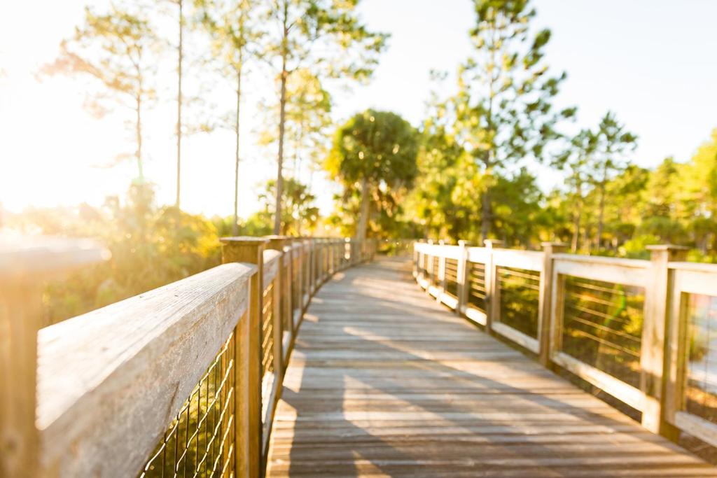 a wooden bridge over a body of water at Salty Beaches by Pristine Property Vacation Rentals in Saint Joe Beach