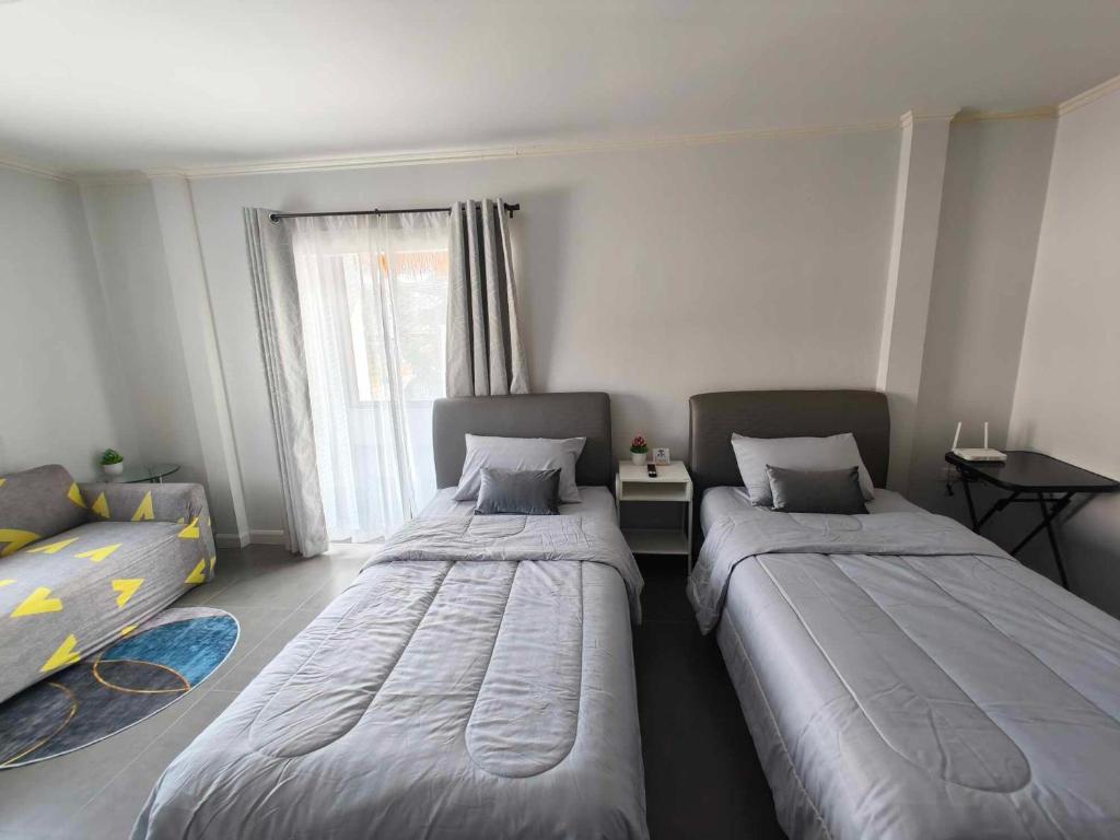 Postel nebo postele na pokoji v ubytování Sawadee Guesthouse Suvarnabhumi