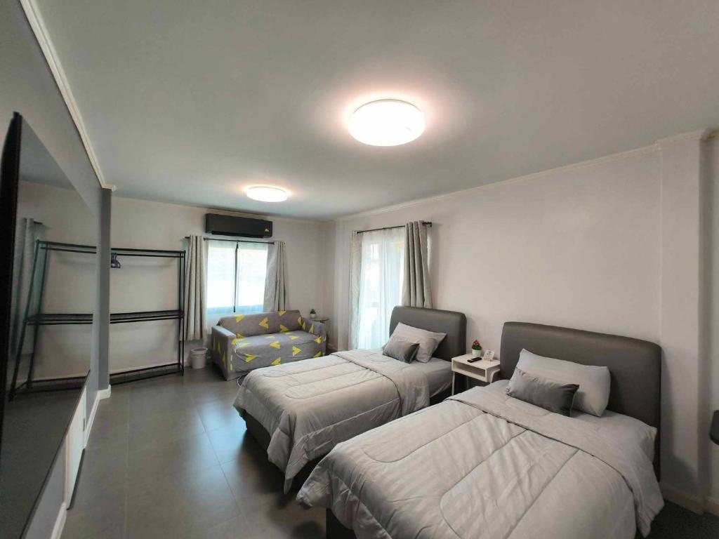 Postel nebo postele na pokoji v ubytování Sawadee Guesthouse Suvarnabhumi