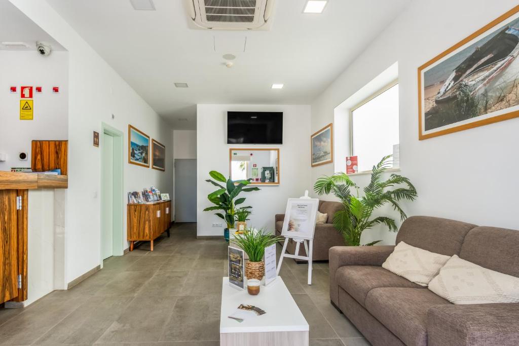a living room with a couch and a table at Hotel Rural Brícia Du Mar in Ferragudo