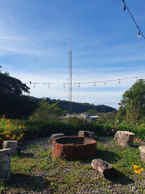 a fire pit in the middle of a garden at Hostal Vista Boquete in Bajo Boquete
