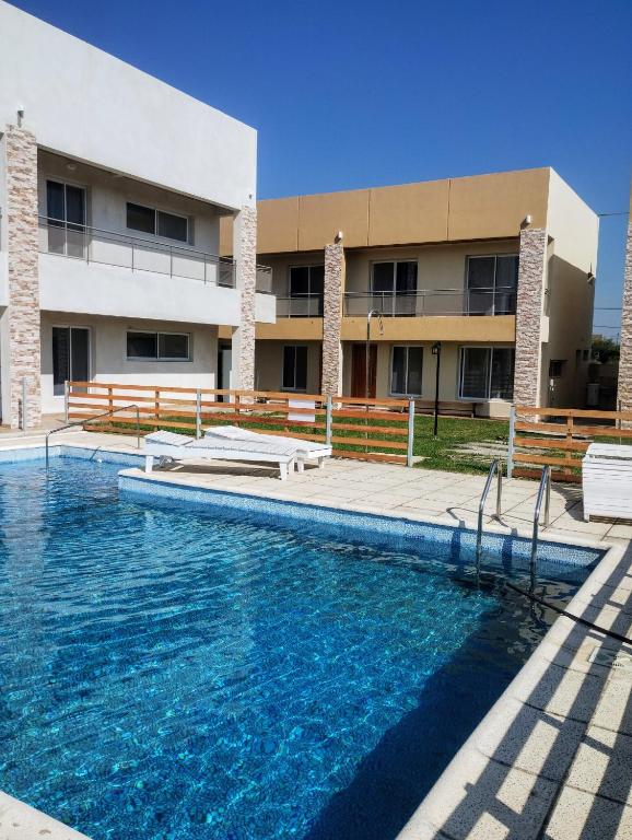 a swimming pool in front of a building at Complejo Marlu in Federación