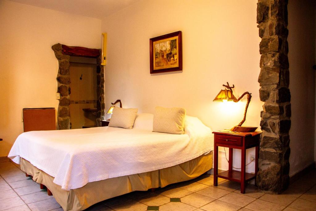Postel nebo postele na pokoji v ubytování Hotel Killa Cafayate