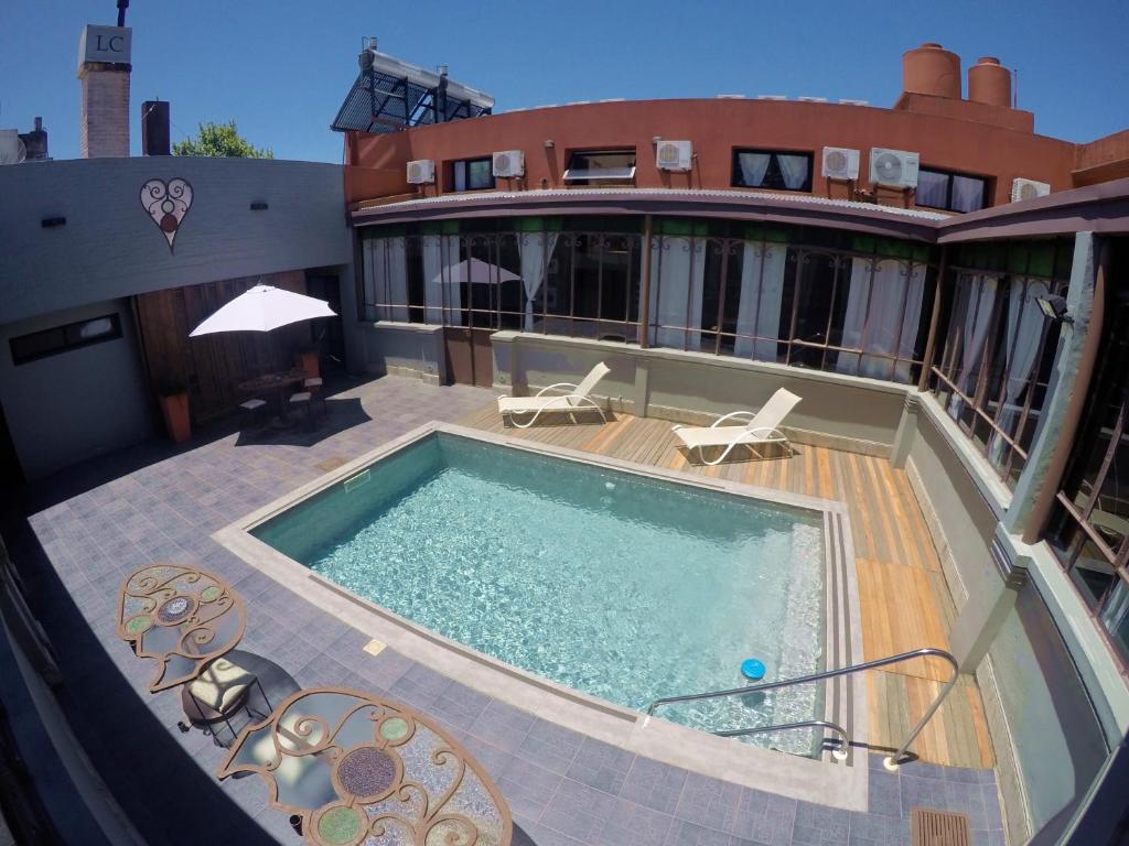 a house with a swimming pool on a patio at Hotel Posada La Comandancia in Melo